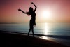 dancing lady sillouette on beach sunset.jpg